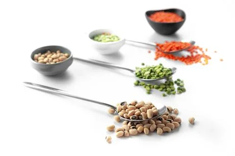 Beans on a spoon on a white background. A set of superfood cereals. Healthy Photos