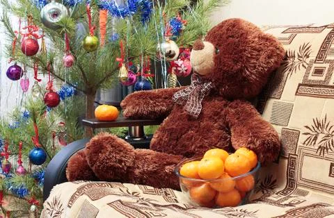 Bear, Christmas tree, tangerines Stock Photos