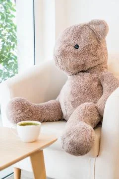 Bear doll sit on sofa Stock Photos