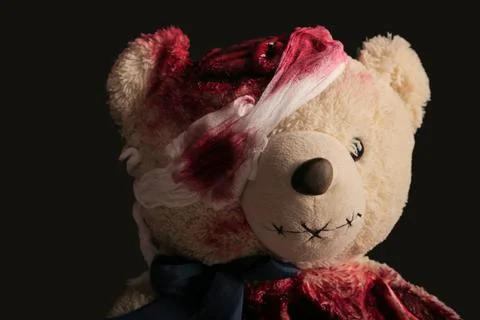 Bear on a gray background close-up with a broken head and a bandaged eye. bra Stock Photos