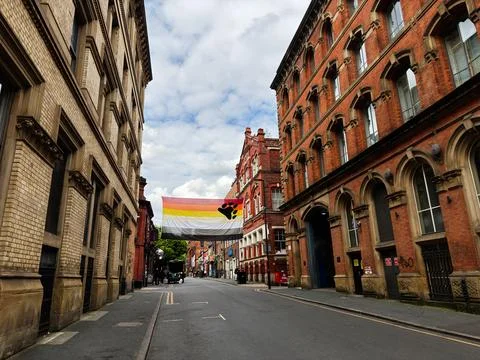 Bear pride flag banner over historic brick street in Manchester, UK with Vi.. Fotos Stock