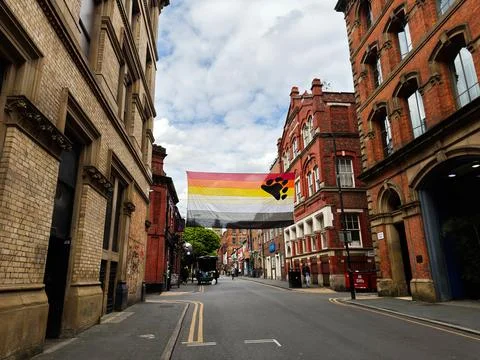 Bear pride flag hanging above a quiet street in Manchester, UK with histori.. Fotos Stock