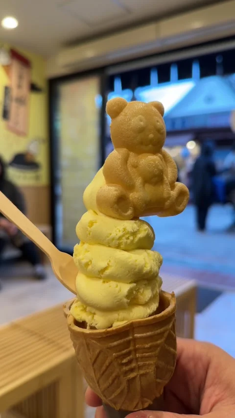 Bear shaped cookie on delicious soft serve ice cream cone Stock Footage 339331089