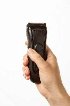Beard clipper in hand Stock Photos