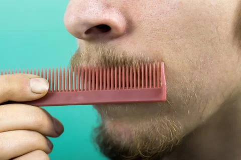 Beard with a comb close-up Stock Photos