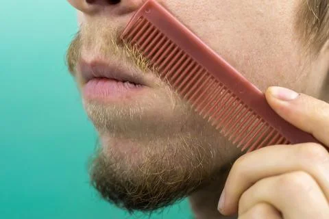 Beard with a comb close-up Stock Photos