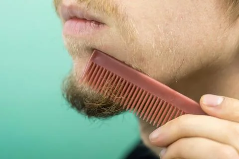 Beard with a comb close-up Stock Photos