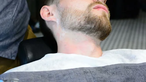Beard cut with straight razor shave. Close up of shaving beard in barber shop. M Video stock 90672024