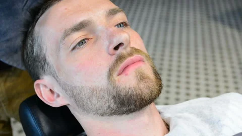 Beard cut with straight razor shave. Close up of shaving beard in barber shop. M Stock Footage 90676449