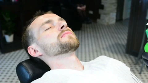 Beard cut with straight razor shave. Close up of shaving beard in barber shop. M Stock Footage 90679628