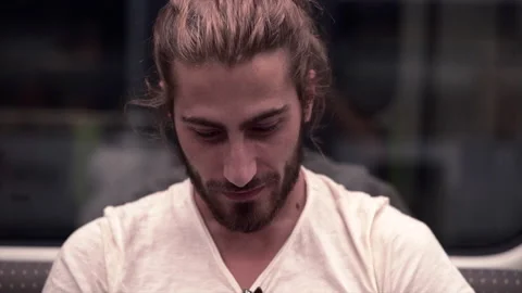 Beard handsome guy smiles sitting in an underground car Video stock 221726331