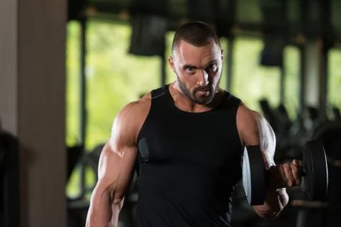Beard Man Exercise Biceps With Dumbbells Stock Photos