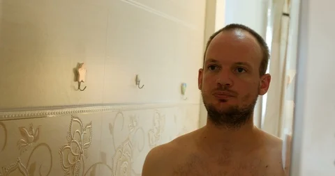 Beard man in front of mirror nervously moving and hitting his face Stock Footage 104417352