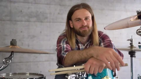 Beard Man looking into the camera. Guy is sitting at the drummers and smiling Stock Footage 155554184