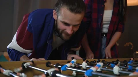 Beard Man Playing Table Kicker At the Party.  Getting Nervous about Losing Stock Footage 150290522