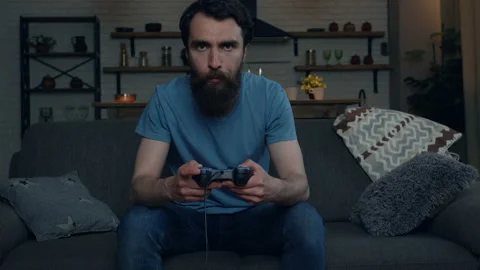Beard man playing video games at home. Loosing game, beating joystick. Stock Footage 108863683