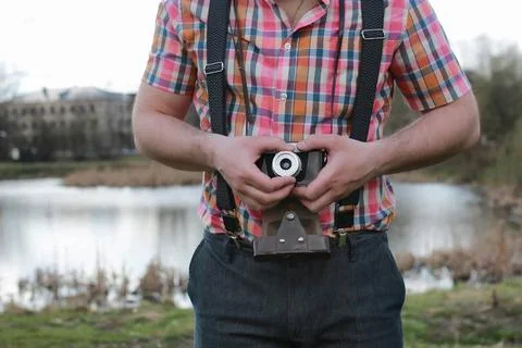 Beard man with retro camera in the park handsome and attractive person in ... Stock Photos