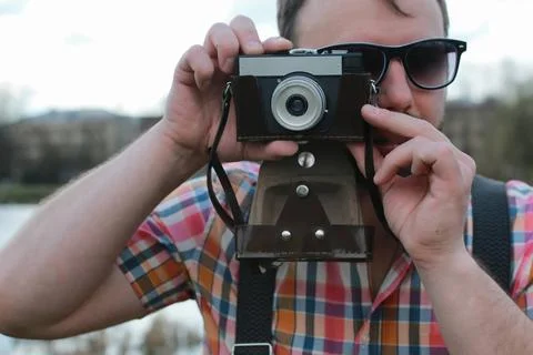 Beard man with retro camera in the park handsome and attractive person in ... Stock Photos