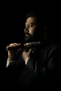 Beard man setting his beard with roller comb Stock Photos