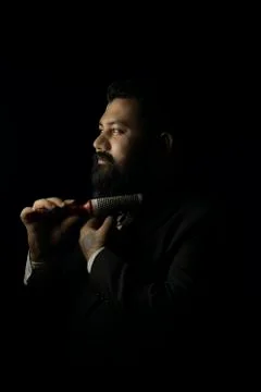 Beard man setting his beard with roller comb Stock Photos