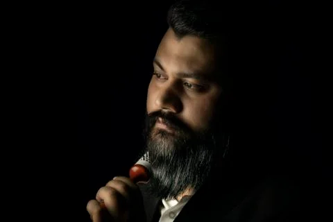 Beard man setting his beard with roller comb Stock Photos