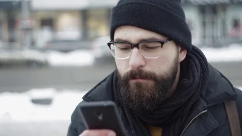 Beard Man typing sms on phone outdoors Stock Footage 71982651