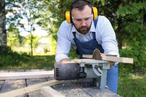 Beard man working on Circular saw desktop items, and the process of prepar... Stock Photos