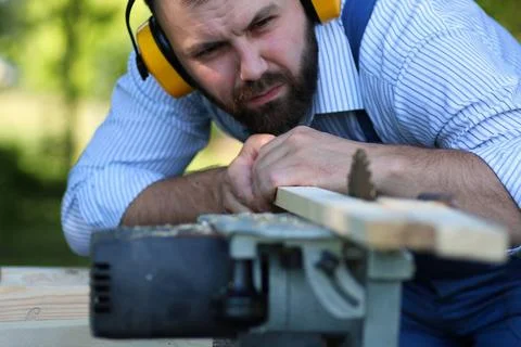 Beard man working on Circular saw desktop items, and the process of prepar... Stock Photos