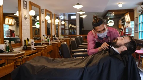 Beard styling. Barber shaping beard of handsome man using a trimmer. Skilled 스톡 동영상 129729187