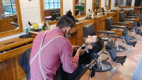 Beard styling. Barber shaping beard of handsome man using a trimmer. Skilled 스톡 동영상 130111615