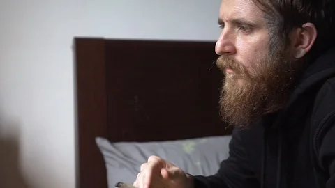 Beard tattooed guy smoke a marijuana joint Video stock 90022645