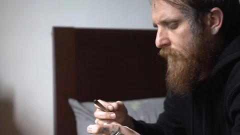 Beard tattooed man smoking a marijuana joint Stock Footage 90021859