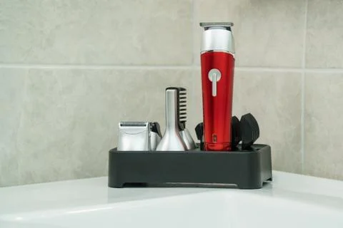 Beard trimmer with attachment in a bathroom closeup Stock Photos