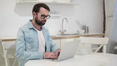 Beard Young Man using Laptop Stock Photos