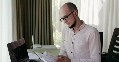 A bearded analyst with glasses looks at the camera and smiles Stock Footage 162180407