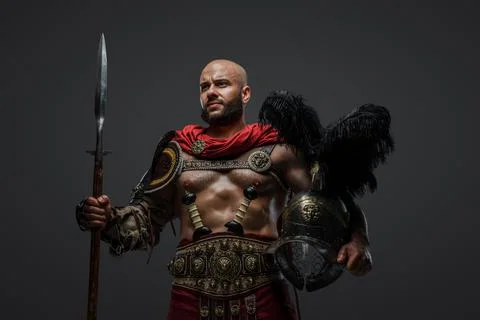 Bearded ancient gladiator with spear and plumed helmet 库存照片