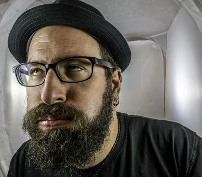 A bearded and annoyed man with empty eyes Stock Photos
