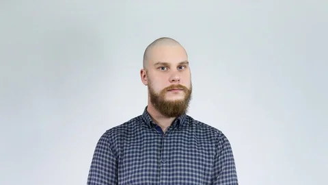 Bearded and the bald guy looks at his reflection and wonders crazy. Stock Footage 122012439