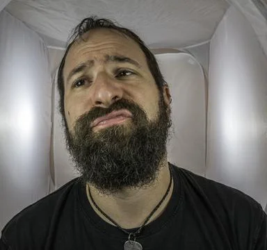 A bearded and disappointed man with empty eyes Stock Photos