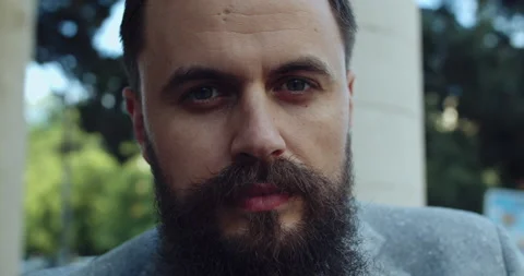 A bearded and elegantly dressed man looks away Stock Footage 140198866