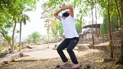 Bearded athlete practices deep squat pos... | Stock Video | Pond5