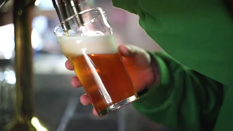 Bearded barman pooring beer from a tap in slow motion Stock Footage 220623062