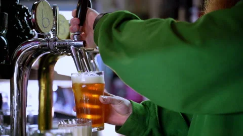 Bearded barman pooring beer from a tap in slow motion Stock Footage 220623083