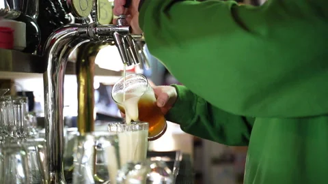 Bearded barman pooring beer from a tap in slow motion Stock Footage 220623112