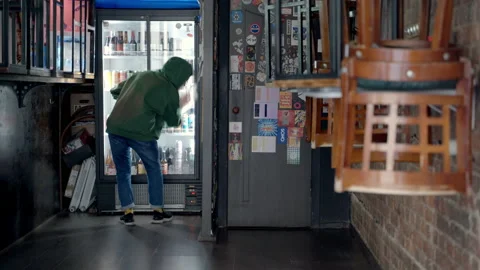 Bearded bartender arranges beer in the fridge in the bar Stock Footage 220652284