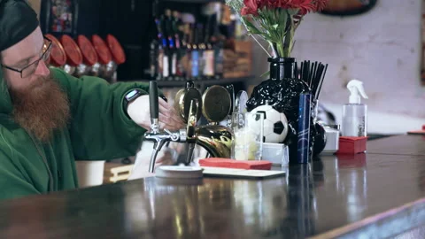Bearded bartender cleans beer tap Stock Footage 220623073