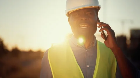 Bearded black foreman talking by mobile phone, professional builder, portrait Stock Footage 318710814