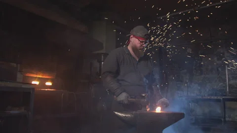 A bearded blacksmith forges a red-hot blank Video stock 146580977
