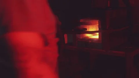 A bearded blacksmith is making new creation from a iron bar 動画素材 108033117