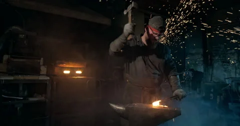A bearded blacksmith working among sparks Видео 146580871